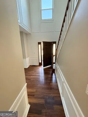 a view of hallway with stairs and wooden floor