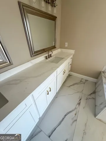 a spacious bathroom with a double vanity sink and mirror