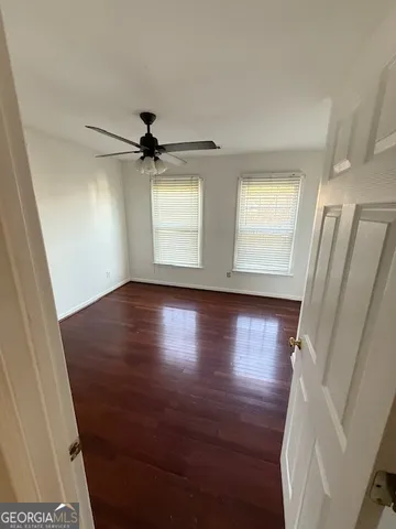 a view of a ceiling fan and wooden floor
