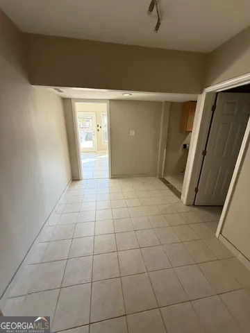 a view of a livingroom with an empty space and a hallway
