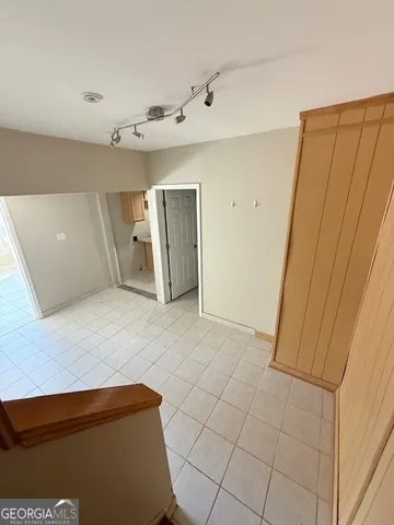 an empty room with a empty space and windows