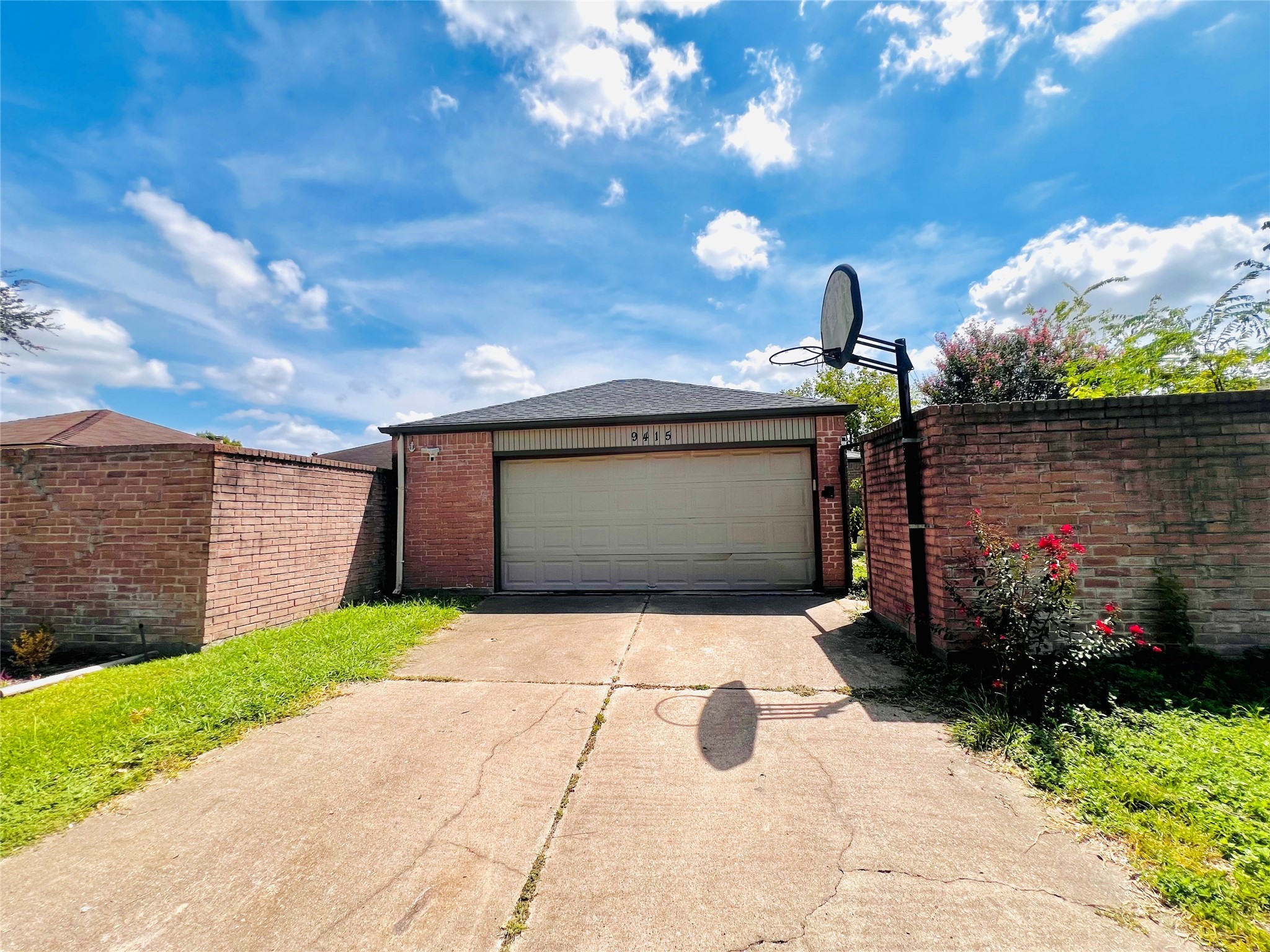 9415 Danforth Way Houston, TX 77083 - Photo 1 of 10 a front view of a house with a yard and garage