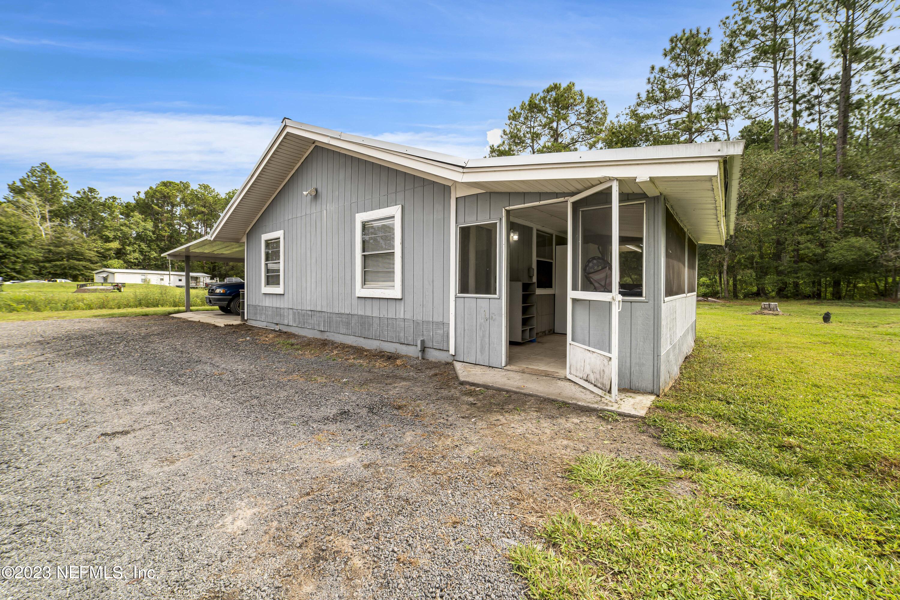 54412 Church Road Callahan, FL 32011 - Photo 33 of 47 a view of a house with a yard and potted plants