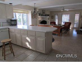 801 Golden Road Tryon, NC 28782 - Photo 7 of 24 a open kitchen with a sink dining table and chairs