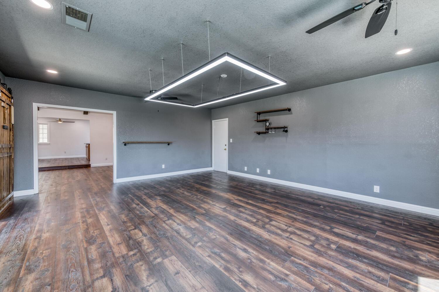 1626 Bliss Avenue Clovis, CA 93611 - Photo 11 of 31 a view of a livingroom with a ceiling fan and wooden floor
