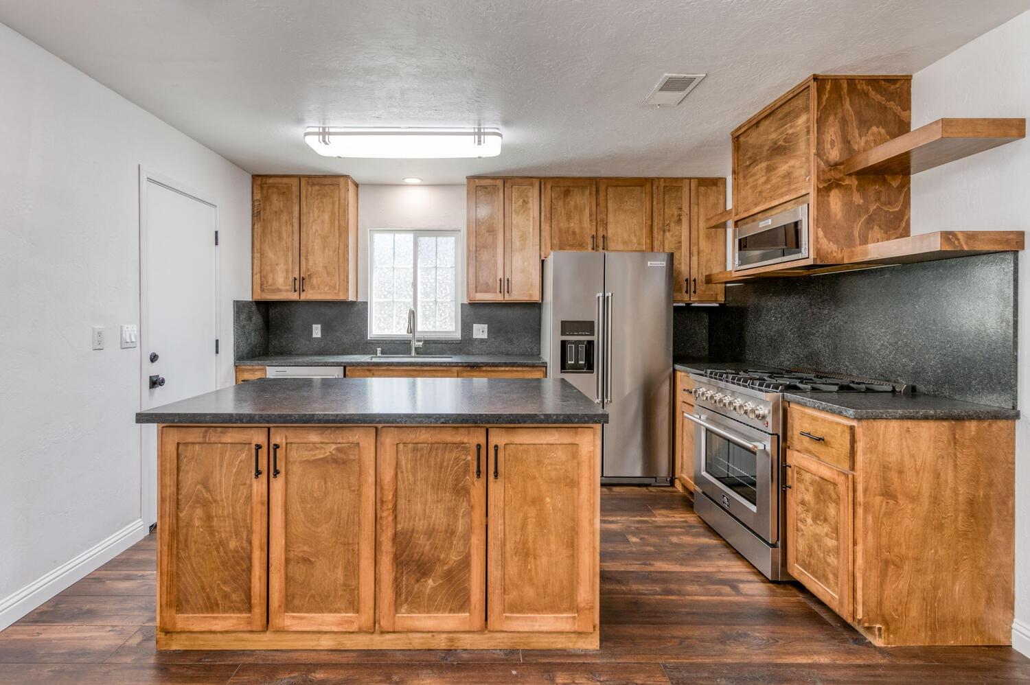 1626 Bliss Avenue Clovis, CA 93611 - Photo 14 of 31 a kitchen with stainless steel appliances granite countertop a refrigerator and a stove top oven