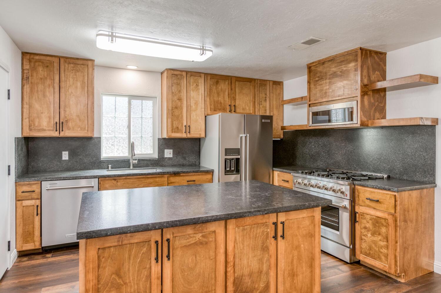 1626 Bliss Avenue Clovis, CA 93611 - Photo 15 of 31 a kitchen with stainless steel appliances granite countertop a stove refrigerator sink and microwave