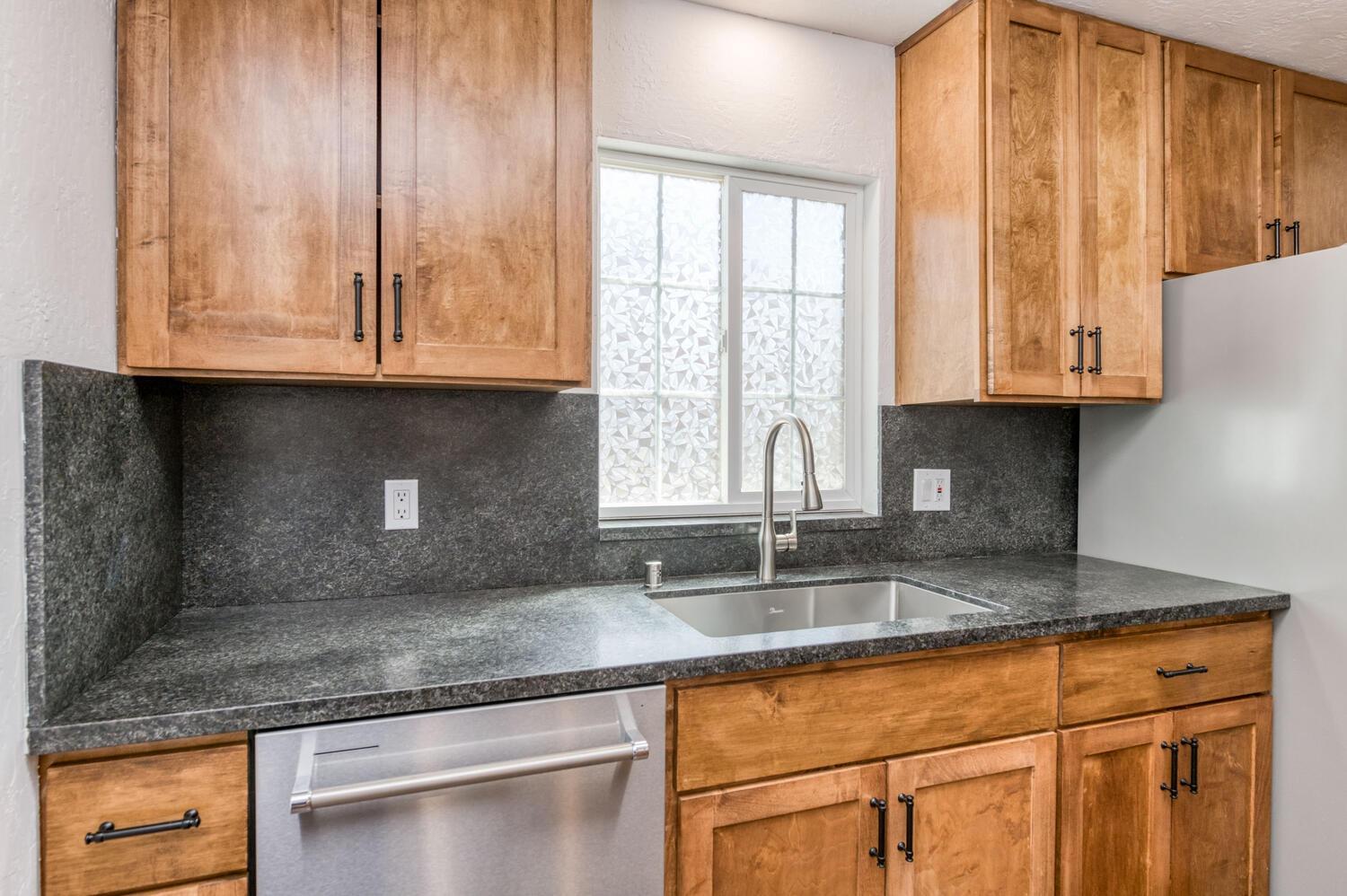 1626 Bliss Avenue Clovis, CA 93611 - Photo 16 of 31 a kitchen with granite countertop cabinets and window