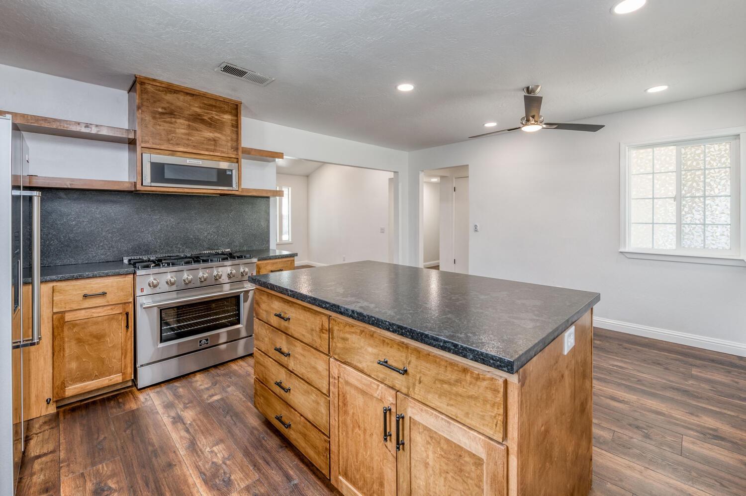 1626 Bliss Avenue Clovis, CA 93611 - Photo 18 of 31 a kitchen with stainless steel appliances granite countertop a stove and a sink
