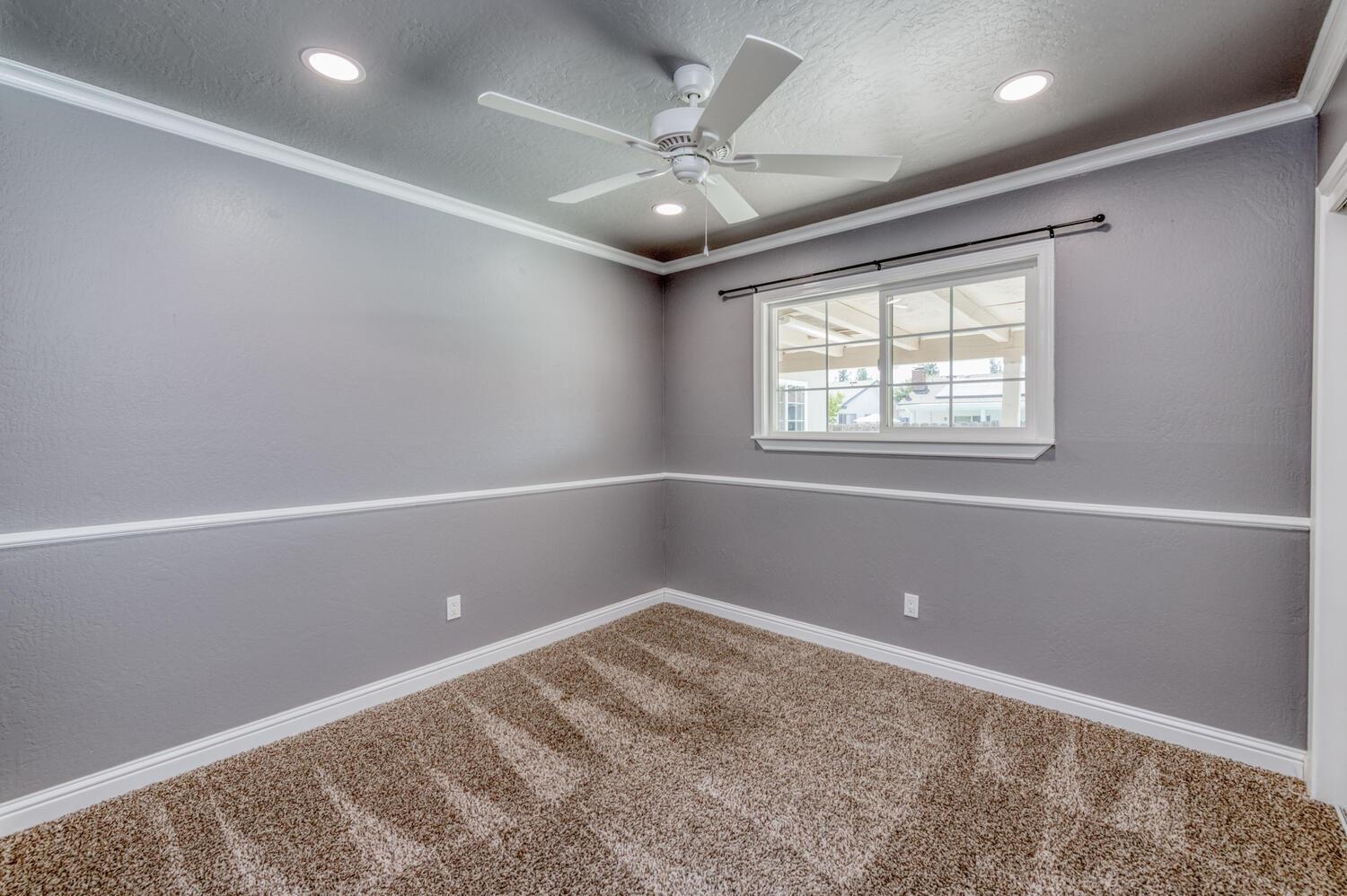 1626 Bliss Avenue Clovis, CA 93611 - Photo 19 of 31 an empty room with windows and ceiling fan