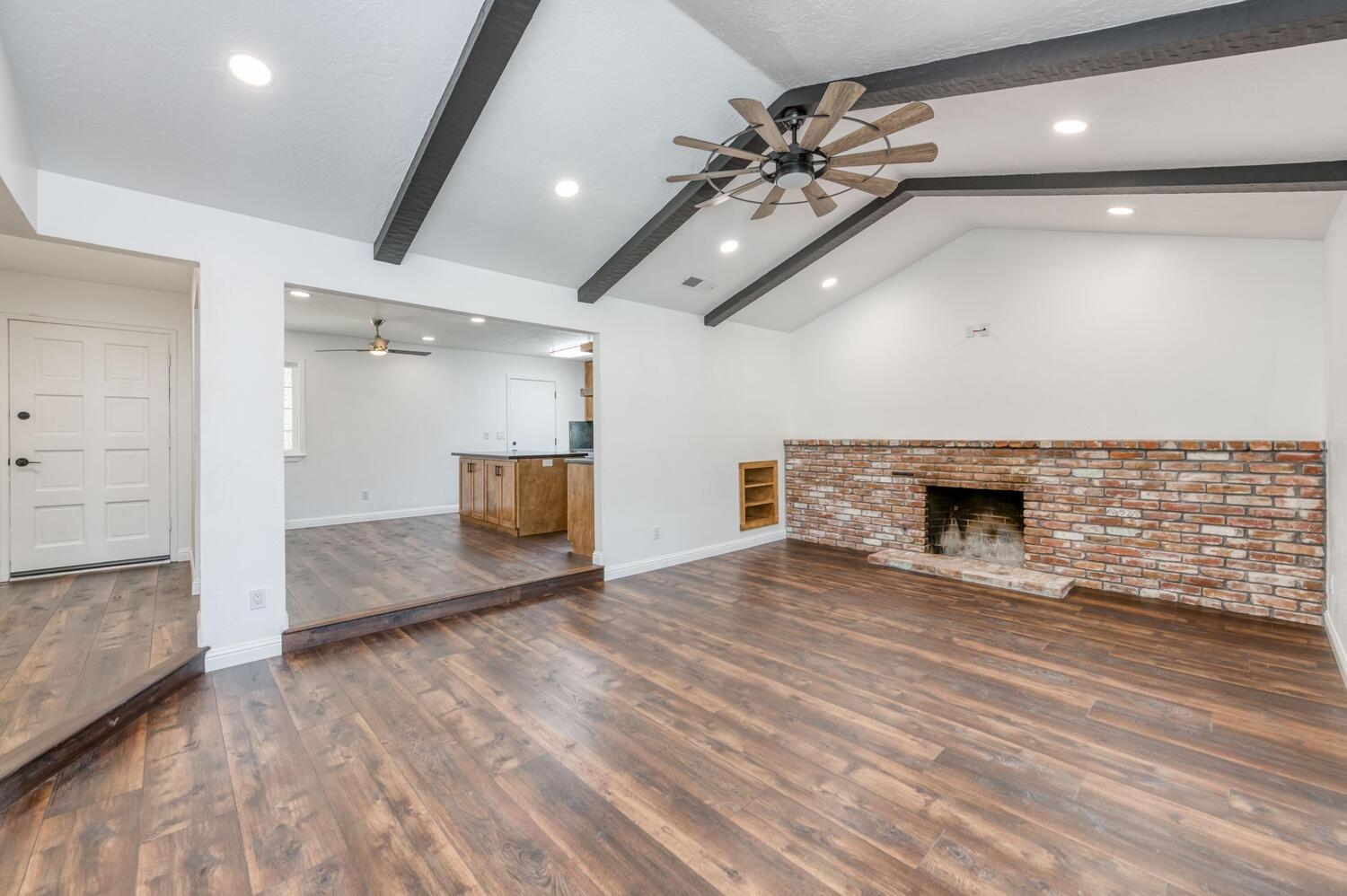 1626 Bliss Avenue Clovis, CA 93611 - Photo 5 of 31 an empty room with wooden floor and chandelier