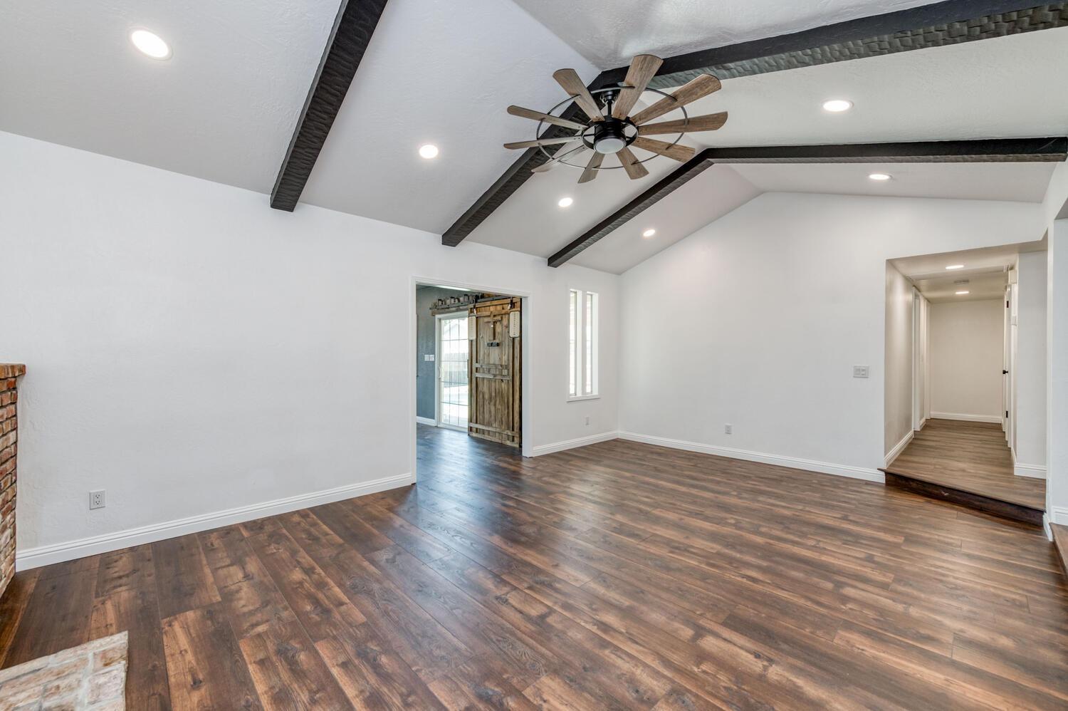 1626 Bliss Avenue Clovis, CA 93611 - Photo 7 of 31 a view of an empty room with wooden floor and a ceiling fan