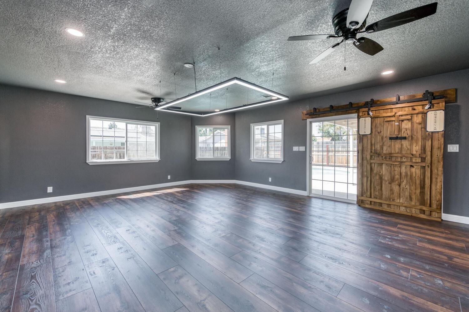 1626 Bliss Avenue Clovis, CA 93611 - Photo 9 of 31 a view of an empty room with wooden floor and a window