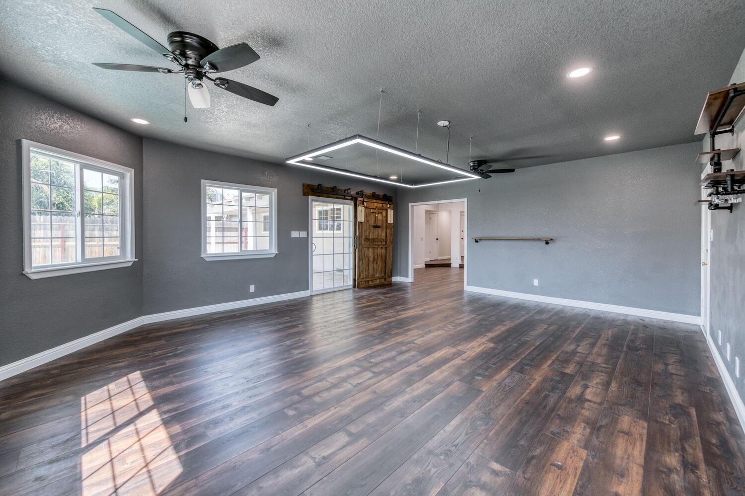1626 Bliss Avenue Clovis, CA 93611 - Photo 10 of 31 a view of an empty room with a window and wooden floor