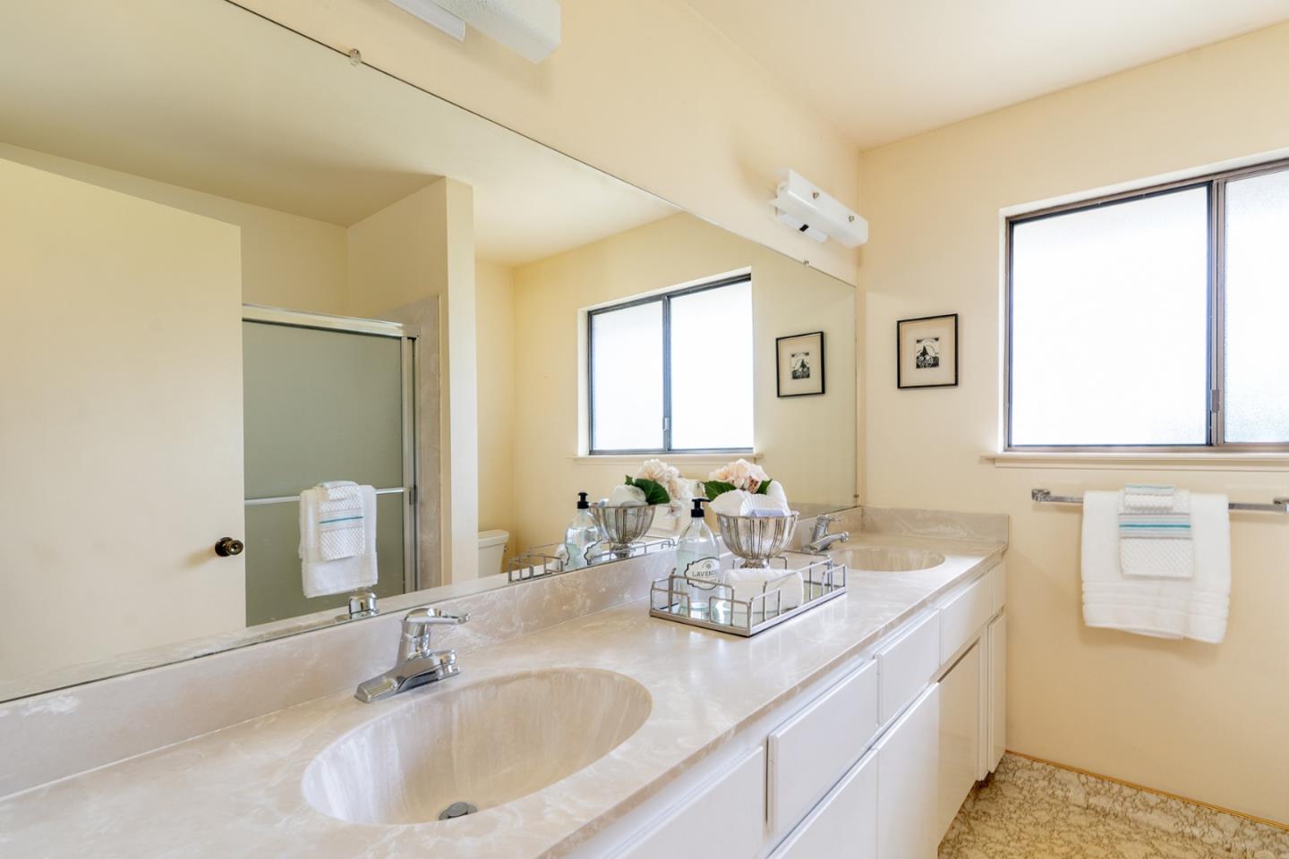 6405 Brookdale Drive Carmel, CA 93923 - Photo 15 of 32 a bathroom with double vanity sinks and a mirror