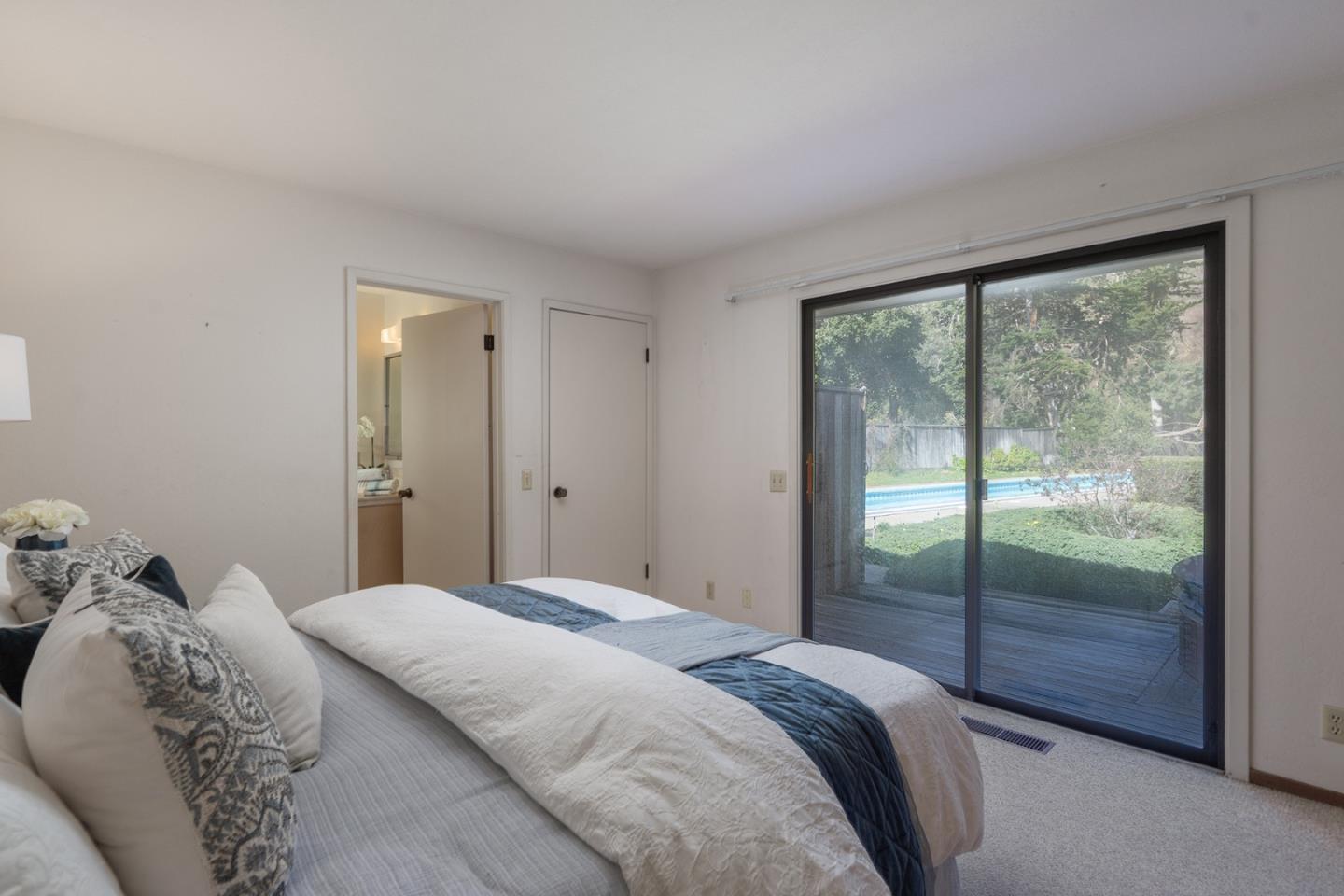 6405 Brookdale Drive Carmel, CA 93923 - Photo 16 of 32 a bedroom with a bed and a large window