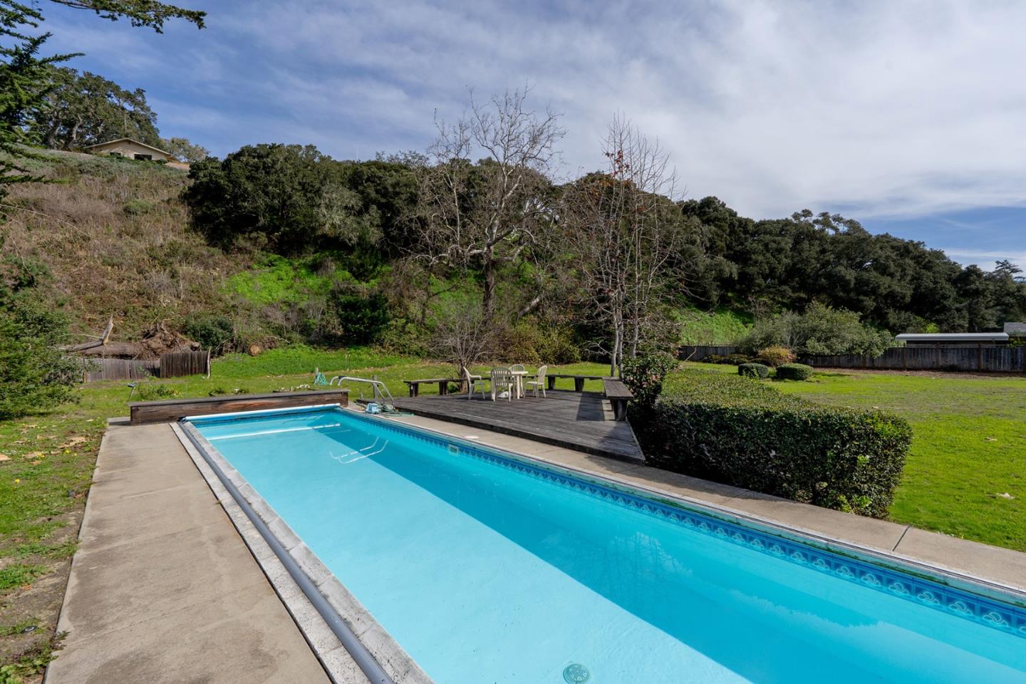 6405 Brookdale Drive Carmel, CA 93923 - Photo 22 of 32 a view of a swimming pool and trees in the background