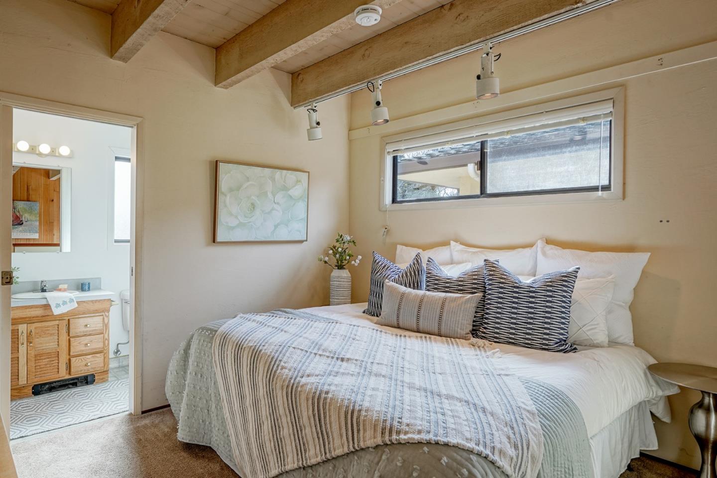 6405 Brookdale Drive Carmel, CA 93923 - Photo 26 of 32 a bedroom with a bed and a night stand