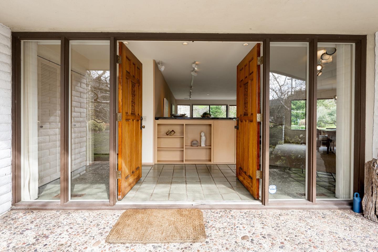6405 Brookdale Drive Carmel, CA 93923 - Photo 4 of 32 a view of a hallway with wooden floor and a living room