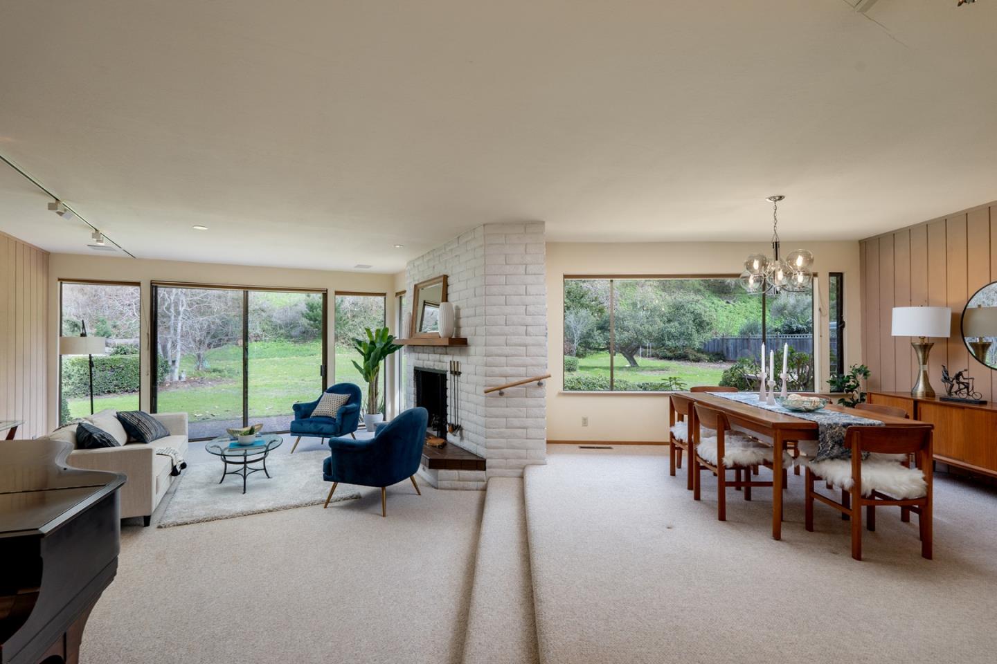 6405 Brookdale Drive Carmel, CA 93923 - Photo 5 of 32 a living room with furniture a fireplace and a large window