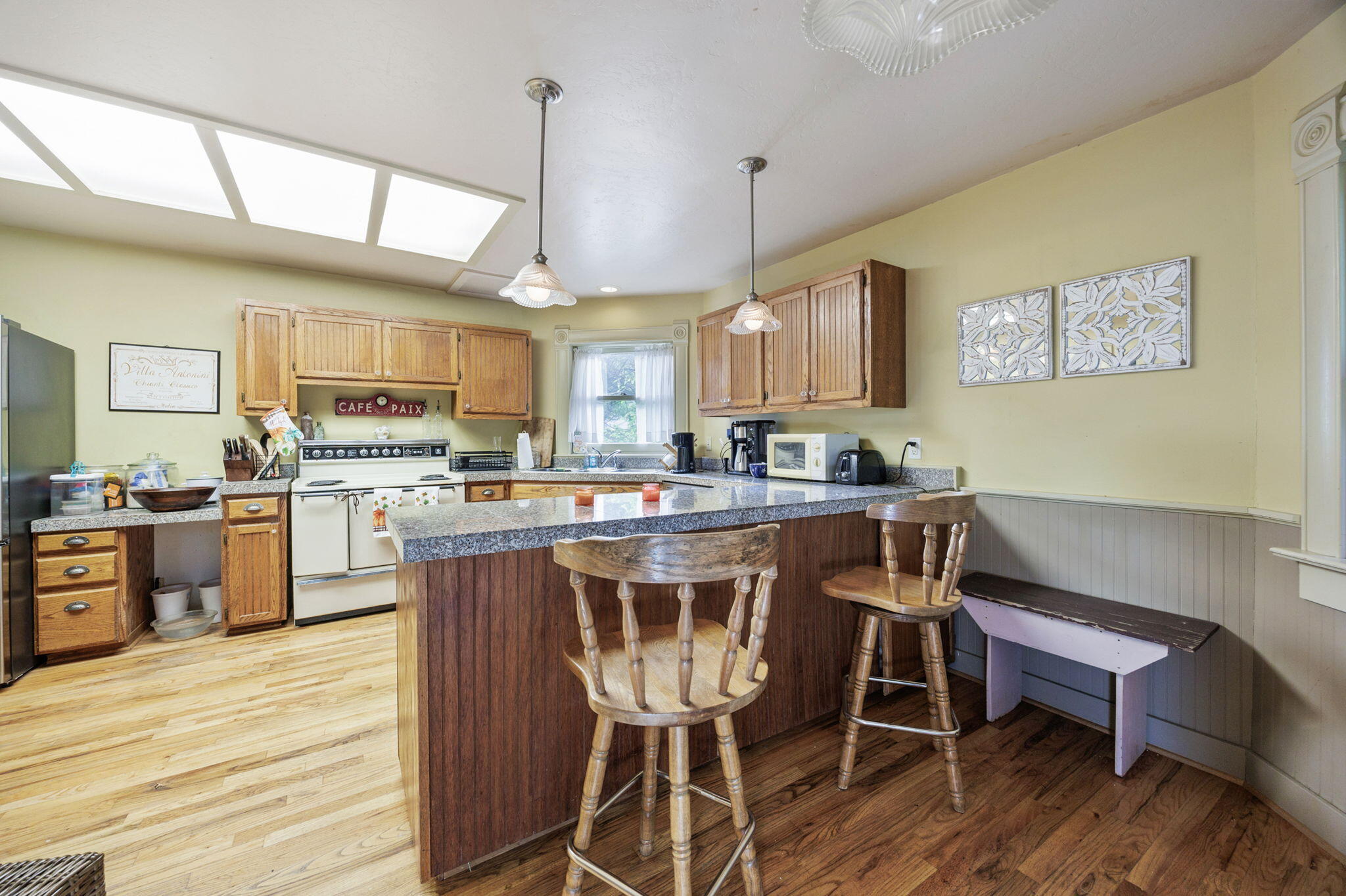 75 Wimer Street Ashland, OR 97520 - Photo 18 of 44 a kitchen with a table chairs refrigerator and cabinets