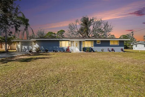a view of house with outdoor space and swimming pool