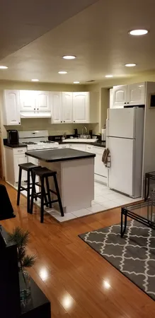 a kitchen with stainless steel appliances granite countertop a sink a stove and a refrigerator