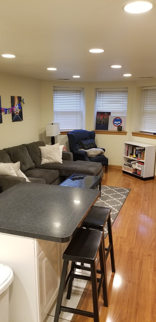 1534 West George Street, Unit G Chicago, IL 60657 - Photo 4 of 12 a living room with furniture and a table