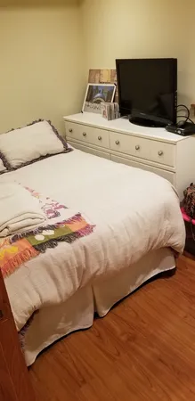 a bedroom with a bed and flat screen tv