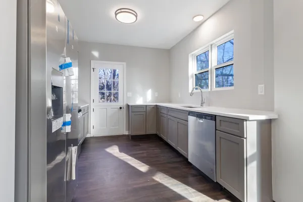 a kitchen with a sink cabinets and window