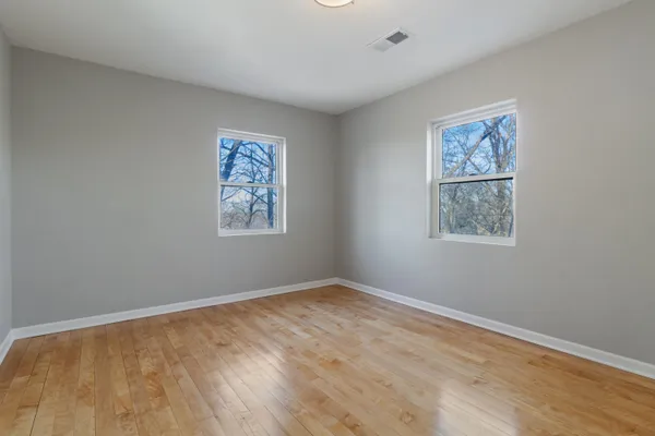 a view of room with window and wooden floor