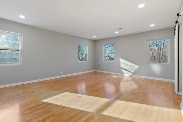 a view of a livingroom with wooden floor and window