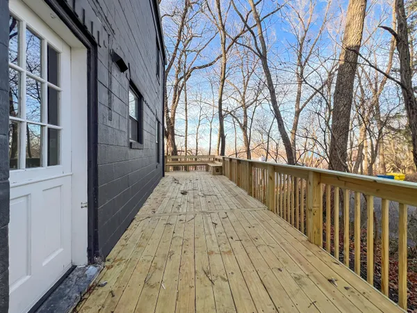 a balcony with wooden floor and fence