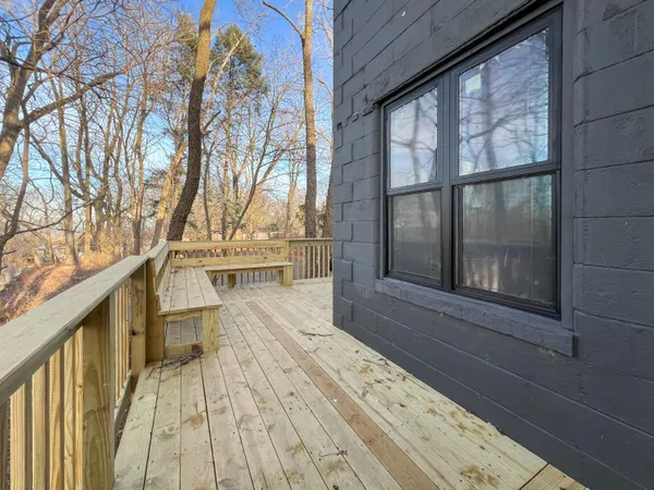 a view of balcony with wooden floor and fence