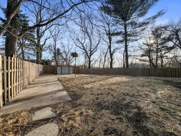 a view of yard covered with snow in front of house