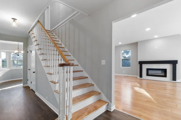 a view of entryway and hall with wooden floor