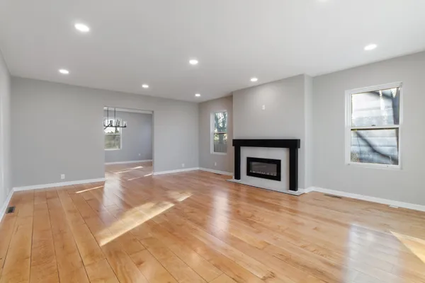 a view of an empty room with a fireplace and a window