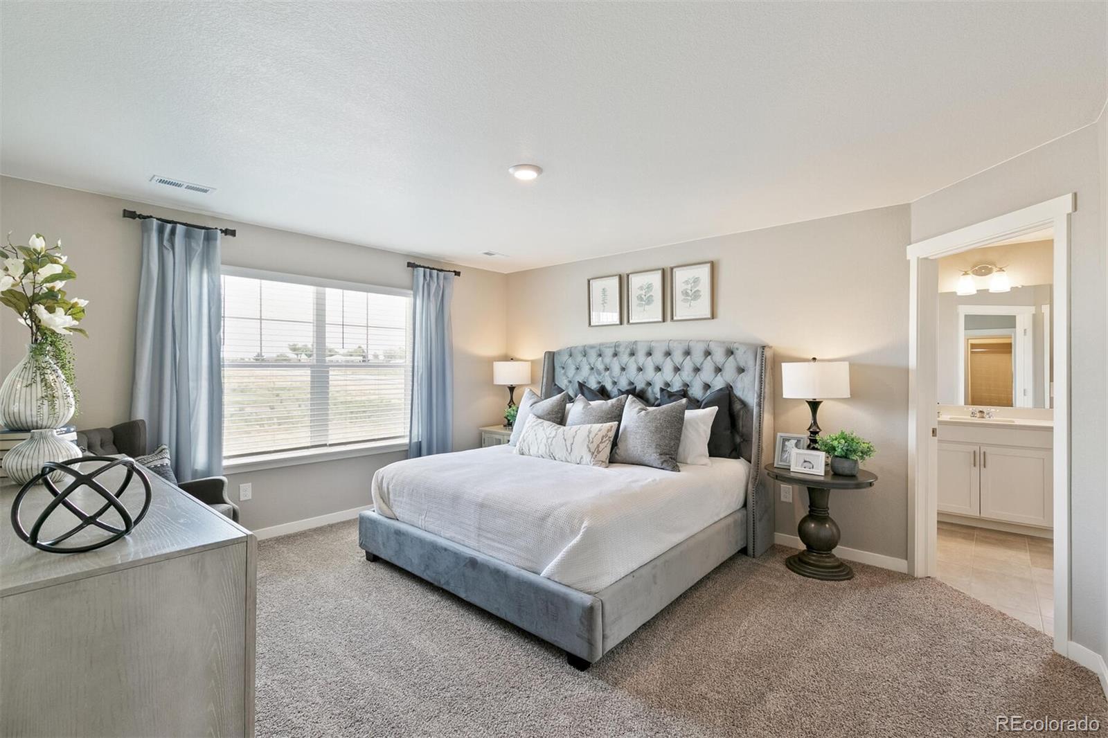 2238 Base Street Fort Lupton, CO 80621 - Photo 19 of 30 a bedroom with a bed a table and chair