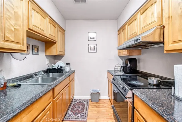 a kitchen that has a sink and a stove