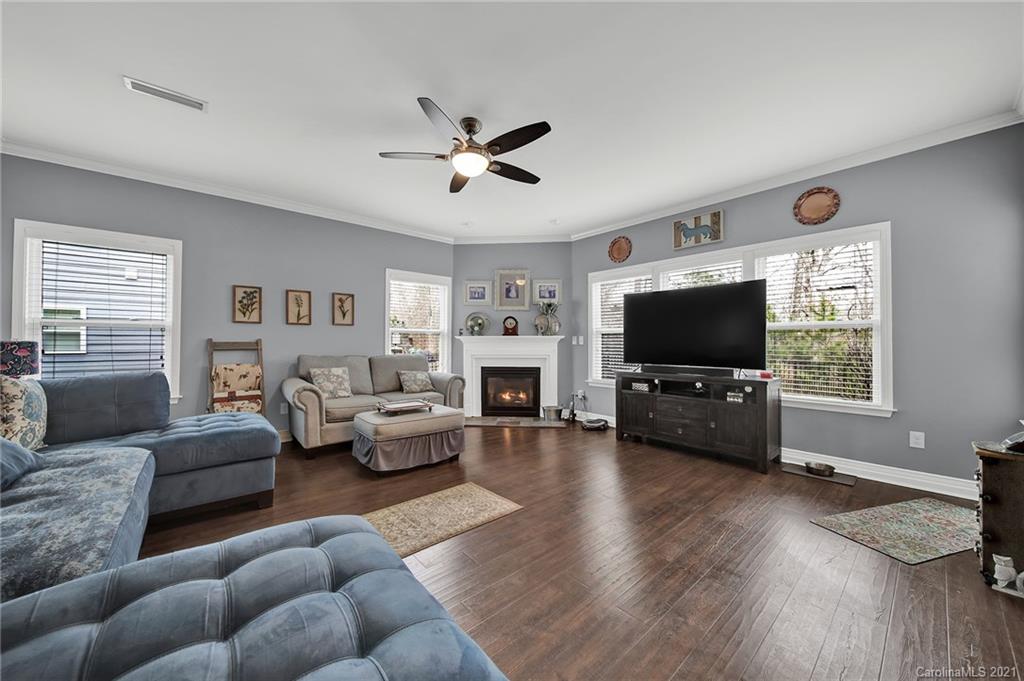 2162 Bluebell Way Tega Cay, SC 29708 - Photo 12 of 37 a living room with furniture a flat screen tv and a fireplace