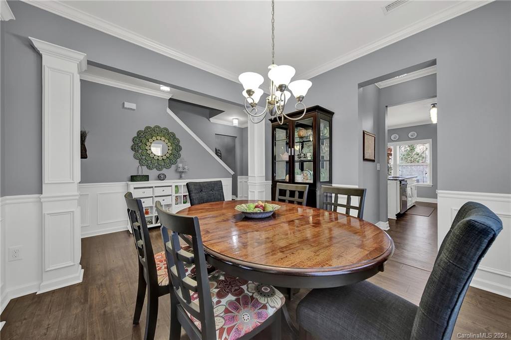 2162 Bluebell Way Tega Cay, SC 29708 - Photo 19 of 37 a view of a dining room with furniture and a chandelier