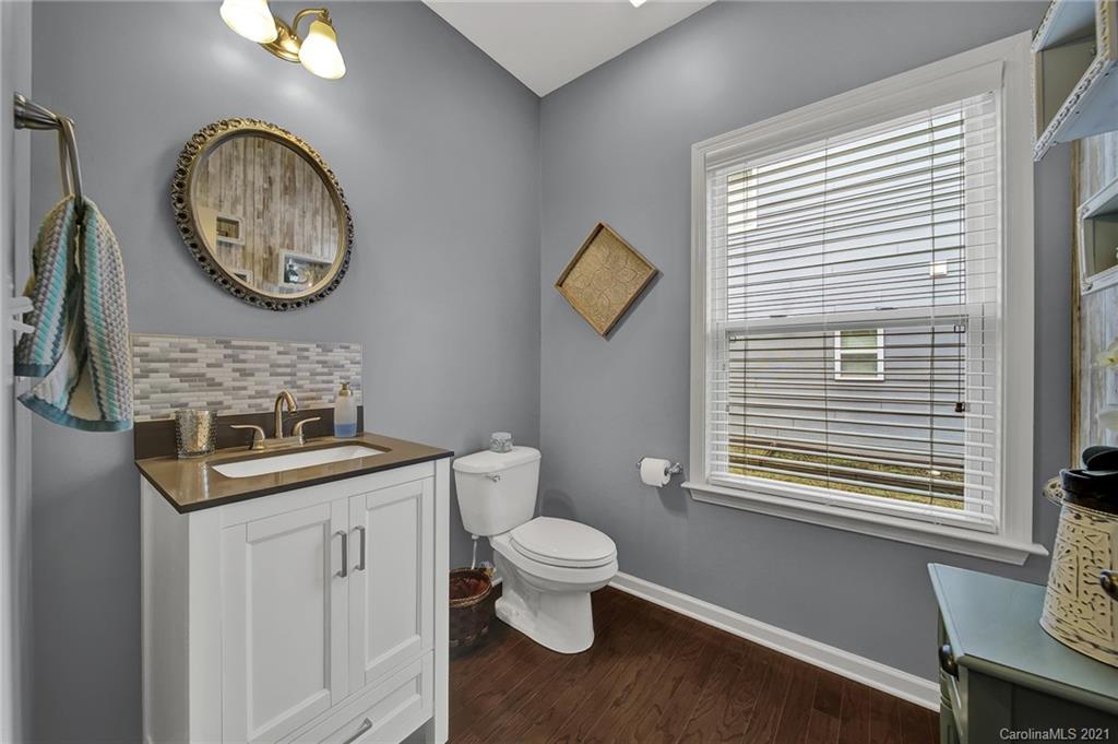 2162 Bluebell Way Tega Cay, SC 29708 - Photo 21 of 37 a bathroom with a toilet a sink and a mirror
