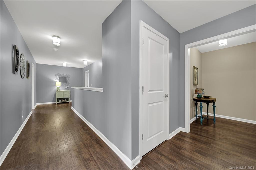 2162 Bluebell Way Tega Cay, SC 29708 - Photo 22 of 37 a view of a hallway with wooden floor