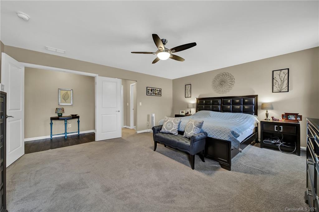 2162 Bluebell Way Tega Cay, SC 29708 - Photo 23 of 37 a spacious bedroom with a bed and dresser