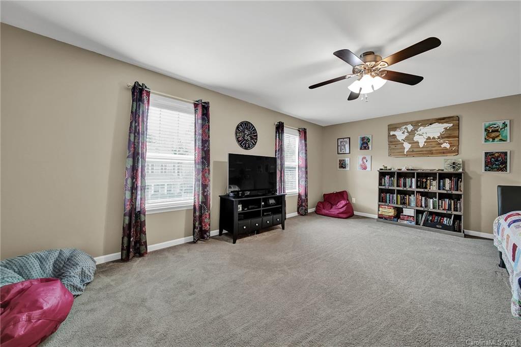 2162 Bluebell Way Tega Cay, SC 29708 - Photo 25 of 37 a view of a livingroom with furniture and a flat screen tv