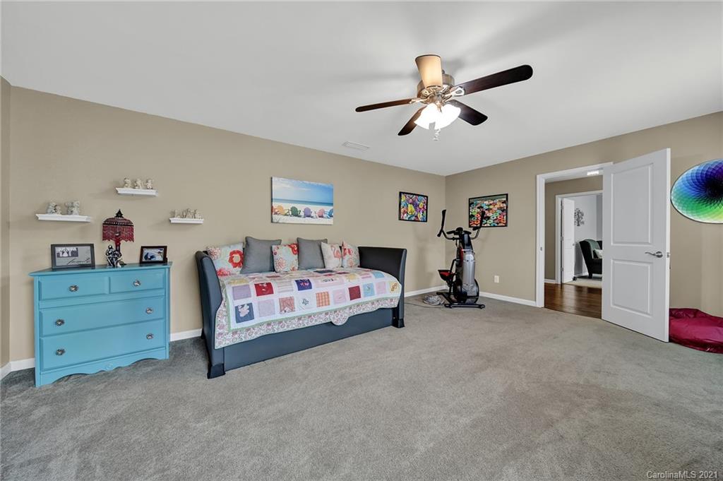 2162 Bluebell Way Tega Cay, SC 29708 - Photo 28 of 37 a spacious bedroom with a bed and a ceiling fan