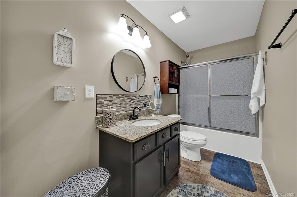 2162 Bluebell Way Tega Cay, SC 29708 - Photo 31 of 37 a bathroom with a sink a toilet and a mirror
