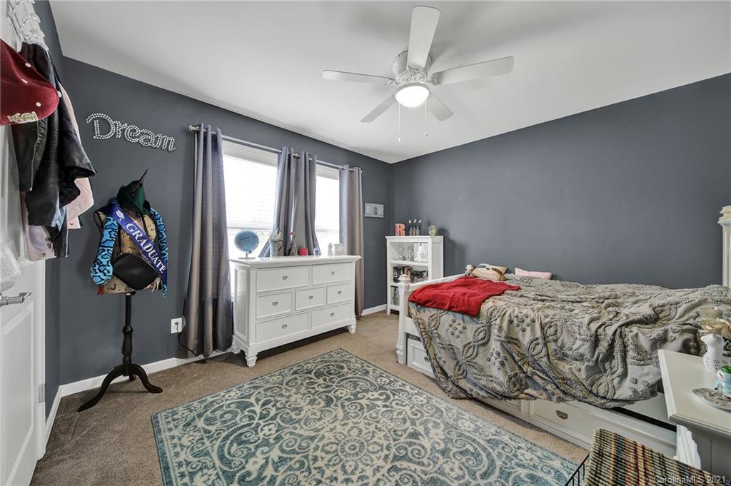 2162 Bluebell Way Tega Cay, SC 29708 - Photo 32 of 37 a bedroom with a bed and a chandelier