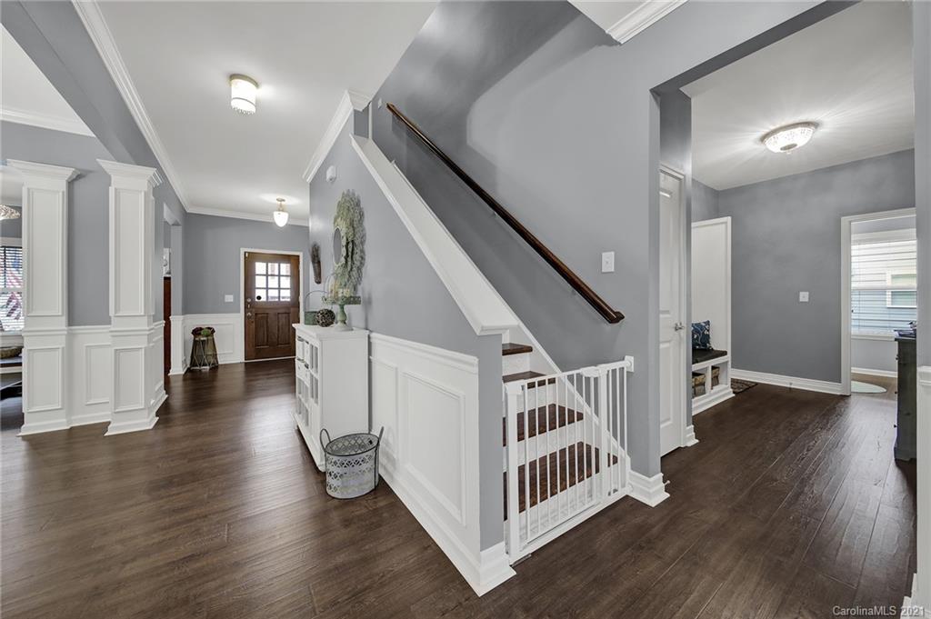 2162 Bluebell Way Tega Cay, SC 29708 - Photo 5 of 37 a view of a livingroom with wooden floor and stairs