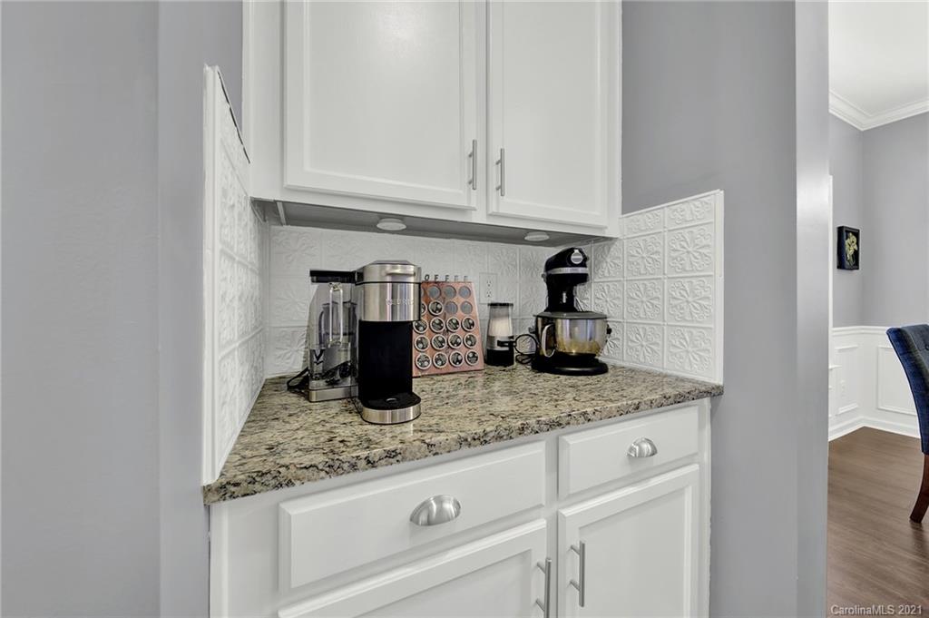 2162 Bluebell Way Tega Cay, SC 29708 - Photo 8 of 37 a kitchen with granite countertop white cabinets and a sink